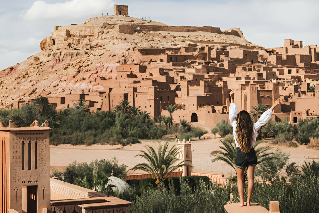 Girl visiting the historic Ait Benhaddou Kasbah on a day trip from Marrakech Morocco