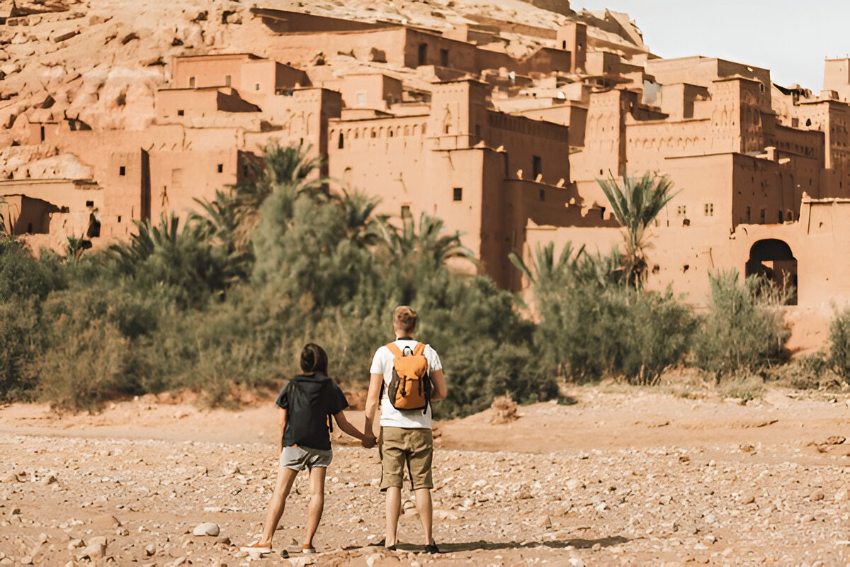 Couple walking in Ait Benhaddou Kasbah during a private desert tour from Ouarzazate Morocco