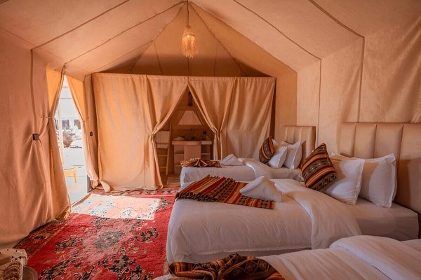 Luxury tent exterior with desert sunset at Zagora desert camp during 2-Day Zagora Desert Tour from Marrakech