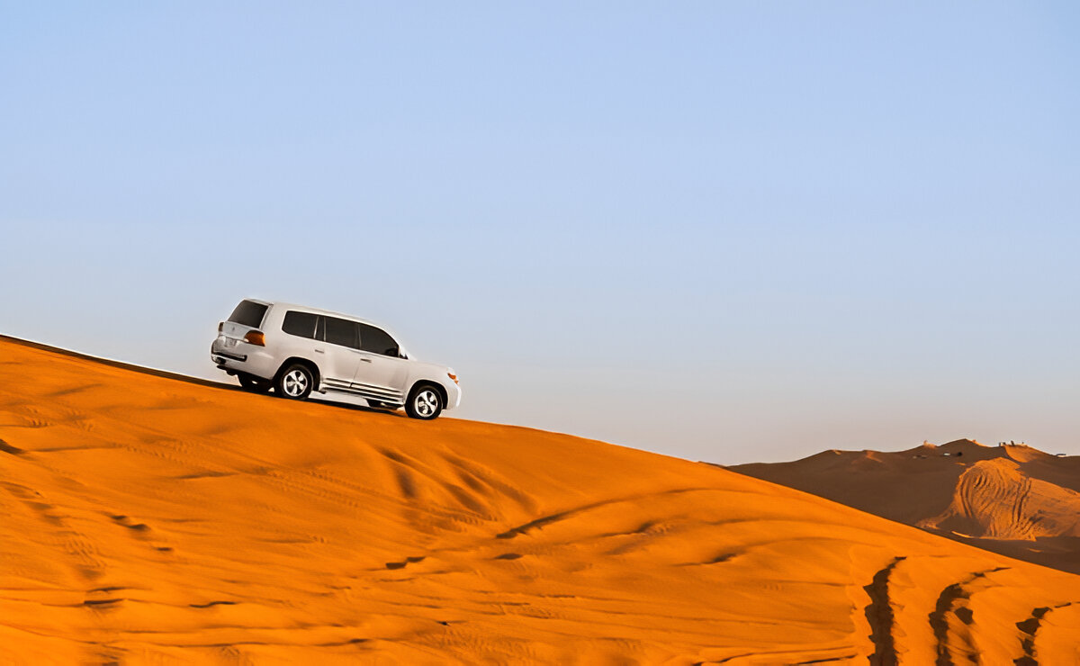 4x4 vehicle crossing the wild dunes of Erg Chigaga Sahara Desert in Morocco