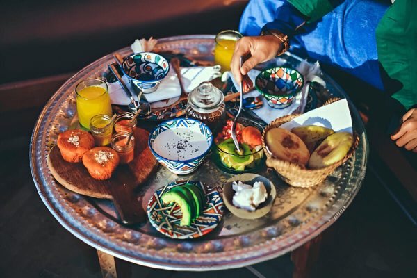 Guests enjoying breakfast at the luxury desert camp in Erg Lihoudi during a 2-day Marrakech desert tour