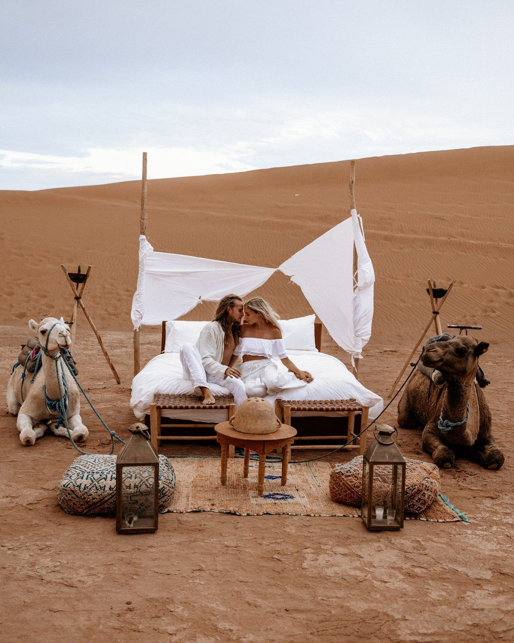 Couple enjoying a luxury desert camp in Zagora Morocco with traditional Berber décor and desert backdrop