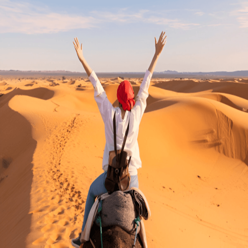 client riding a camel in Erg Lihoudi dunes during a 2 day desert tour from Marrakech