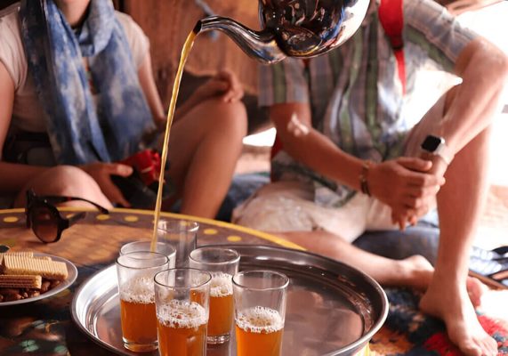 Traveler with nomad in Erg Chigaga desert during a 2-day Sahara tour from Ouarzazate