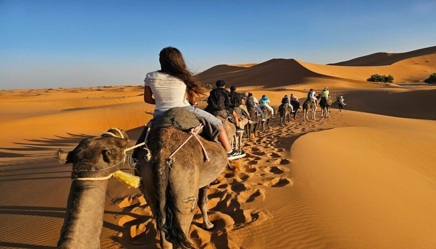 Traveler enjoying the Sahara dunes on a 2-day shared Marrakech to Zagora desert tour