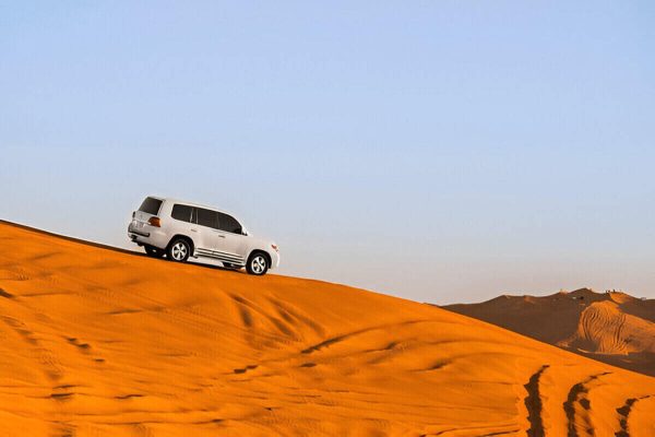 4x4 vehicle driving through the large Erg Chigaga sand dunes during a 3-day Marrakech desert tour