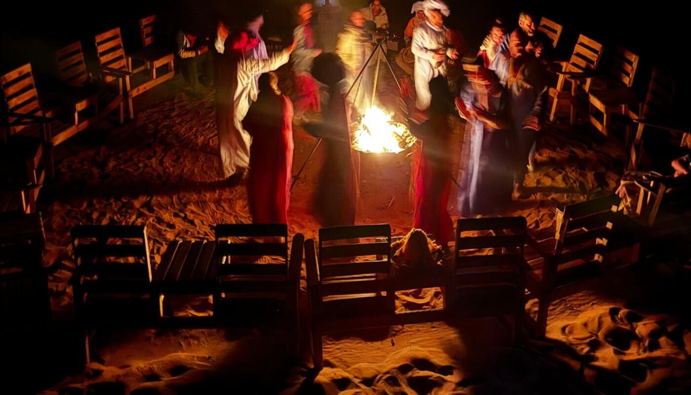 Guests enjoying traditional Berber music at a luxury desert camp in Zagora