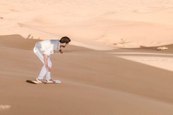Sandboarding in the Sahara during a 3-day shared Marrakech to Merzouga desert tour
