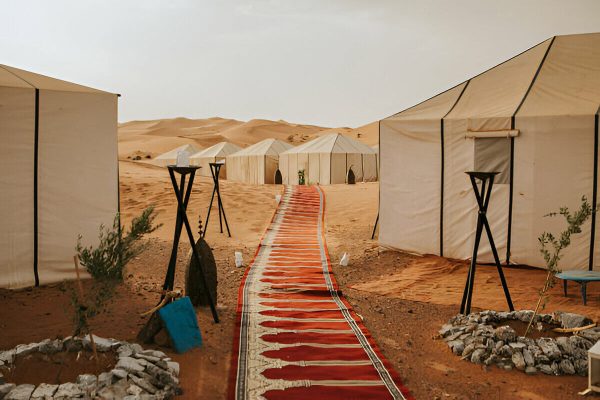 Luxury desert camp in Morocco surrounded by Sahara dunes
