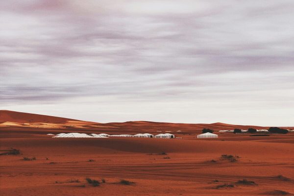 Luxury desert camp surrounded by Sahara dunes in Morocco