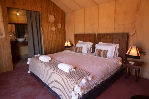 Luxury desert tent with comfortable bedding and Moroccan-inspired decoration